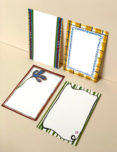 Picture of the four options of menu card available with patterns including tartan, abstract florals and squiggle borders